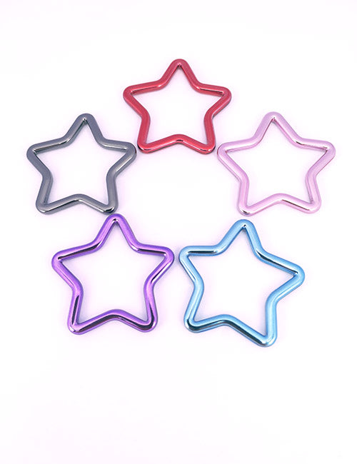 Five metallic star-shaped Adornments by YIPAI in red, pink, blue, purple, and gray are arranged in a circle on a white background.
