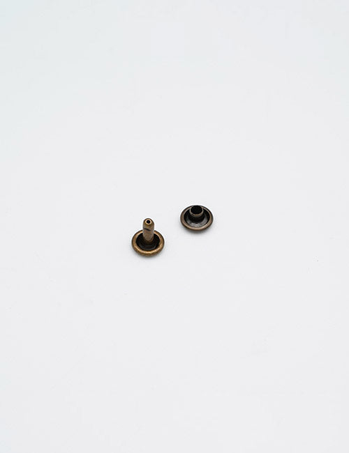 Two small YIPAI Adornments snap fasteners, one displaying the post side and the other the socket side, are shown on a plain white background.