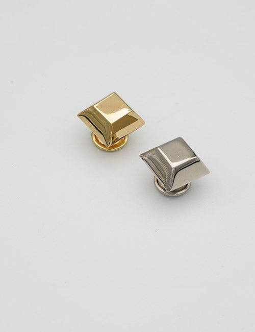 Two pyramid-shaped Adornments lapel pins by YIPAI, one gold and one silver, shown on a plain white background.