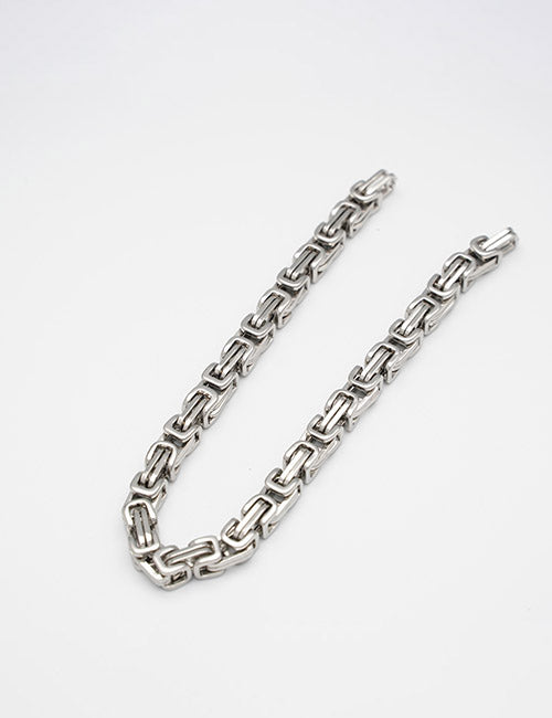 The YIPAI Chains necklace features thick, silver rectangular links and is displayed in a loose curve on a plain white background.
