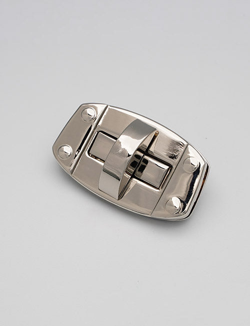 A YIPAI Closures shiny silver metal latch lock with a curved lever and four screw holes is set against a plain, light gray background.