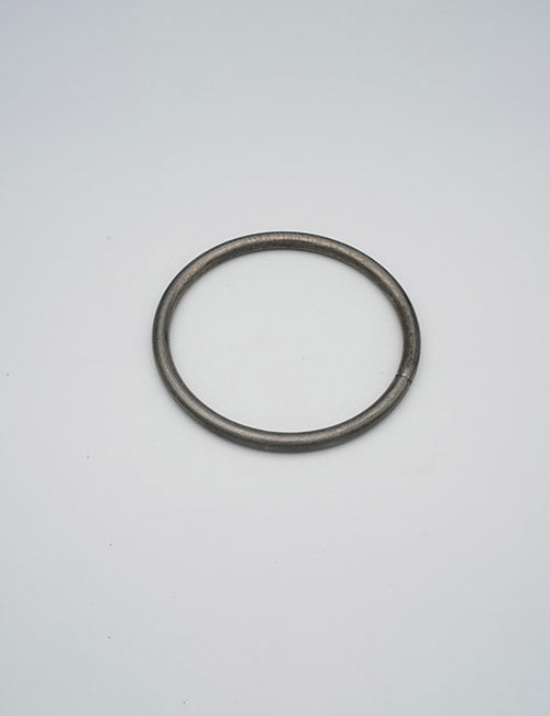A single YIPAI Rings & Slides metallic ring rests flat and centered on a white surface.