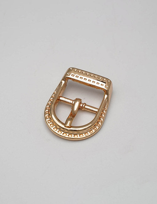 The YIPAI Buckles gold-colored metal belt buckle features a rectangular top, rounded bottom, and decorative dotted edge pattern, shown on a plain light gray surface.