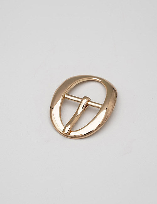 A shiny, oval-shaped gold belt buckle from YIPAI Buckles, featuring a central prong, displayed on a plain light gray background.