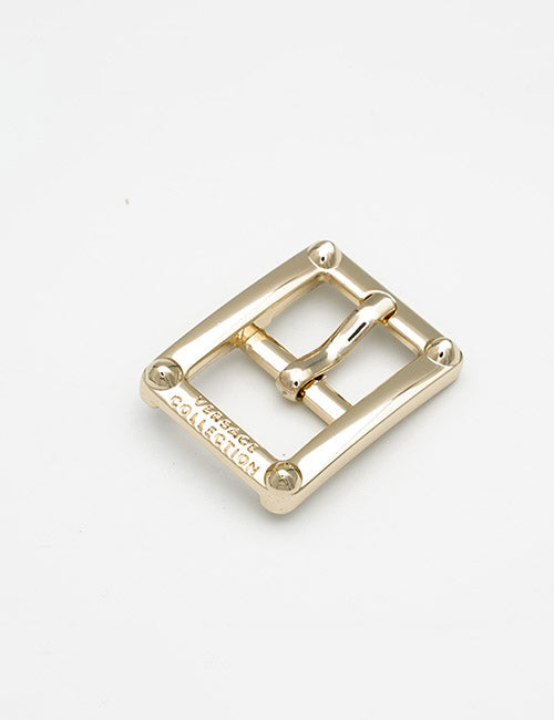 A rectangular gold-colored YIPAI Buckles metal belt buckle with four rounded corners and “COLLECTION” engraved on one side, displayed on a plain white background.