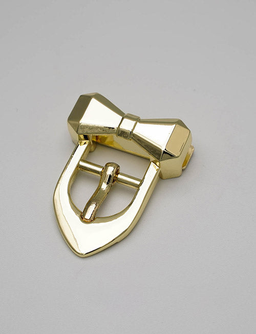 A YIPAI Buckle shaped like a shiny gold bow tie with a pointed tip, displayed on a plain light gray background.