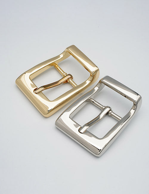 Two YIPAI Buckles, one in gold and one in silver, are displayed side by side on a plain white background.