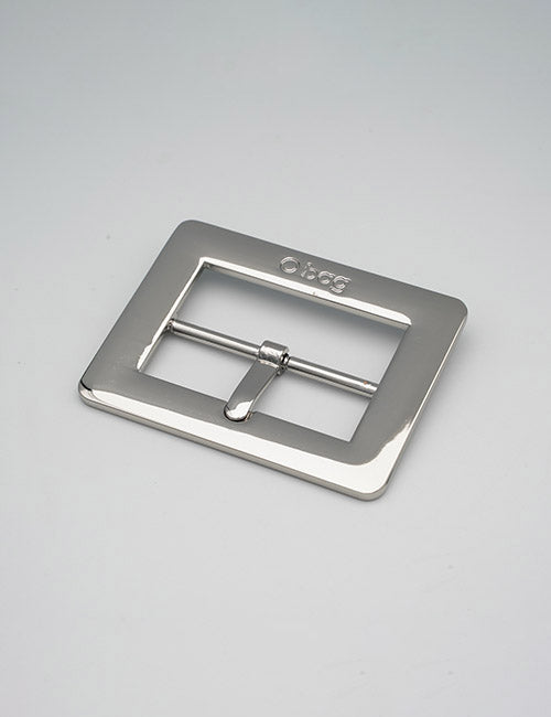 A shiny, rectangular silver YIPAI Buckle with a central prong rests on a light gray surface. The brand name is engraved on the top edge.