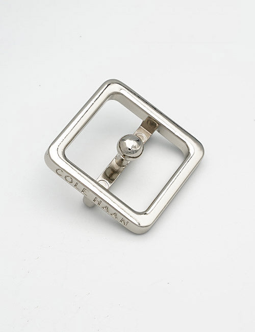 A silver rectangular metal belt buckle with a prong, engraved with YIPAI on one edge, is displayed on a plain white background. Product Name: Buckles.