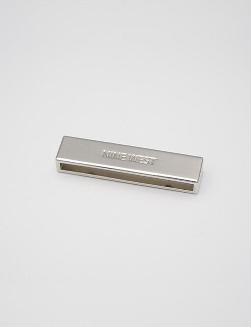 A rectangular, silver metal buckle with YIPAI engraved on the top, placed on a plain white background.