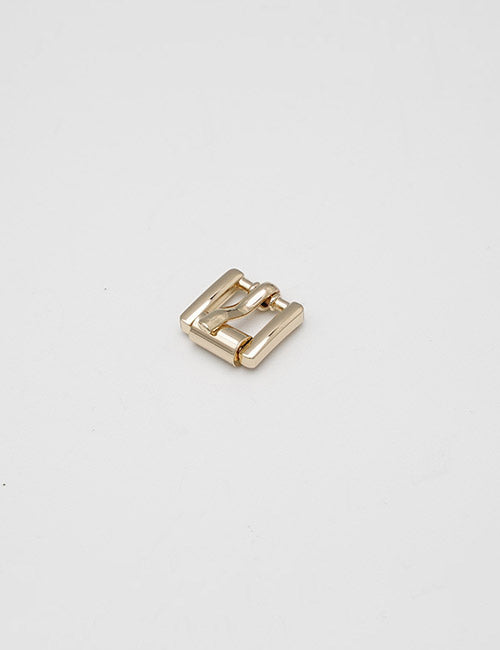 A YIPAI Buckles gold-colored metal watch link rests on a plain white background.