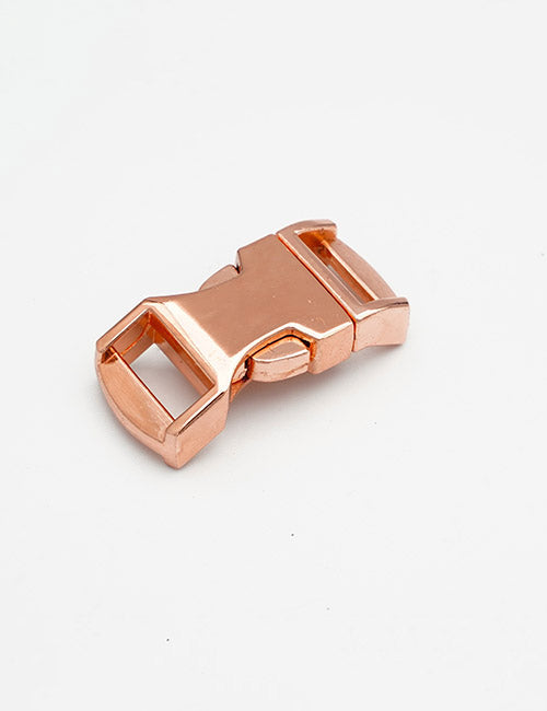 A YIPAI Buckles rose gold plastic side release buckle, ideal for straps or belts, is displayed on a plain white background.