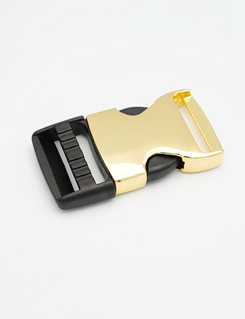 A YIPAI Buckles gold and black plastic side-release buckle with a shiny gold clasp and black adjustable strap ends is displayed on a white surface.