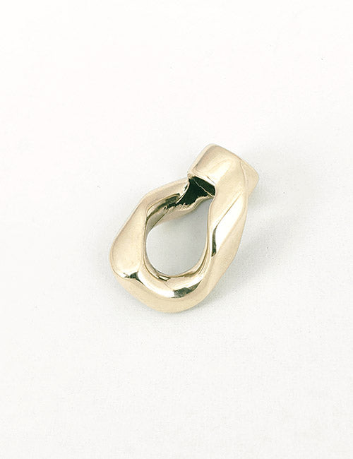 The YIPAI Chains is an abstract, gold-colored metal piece with a smooth, twisted, irregular shape. Featuring an open center and rounded edges, it is displayed on a plain white background.