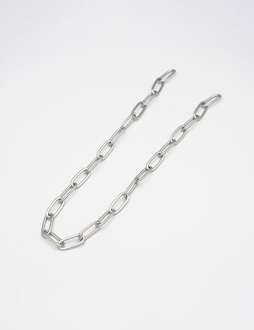The YIPAI Chains feature silver metal with elongated oval links, elegantly arranged in a loose curve on a plain white background.