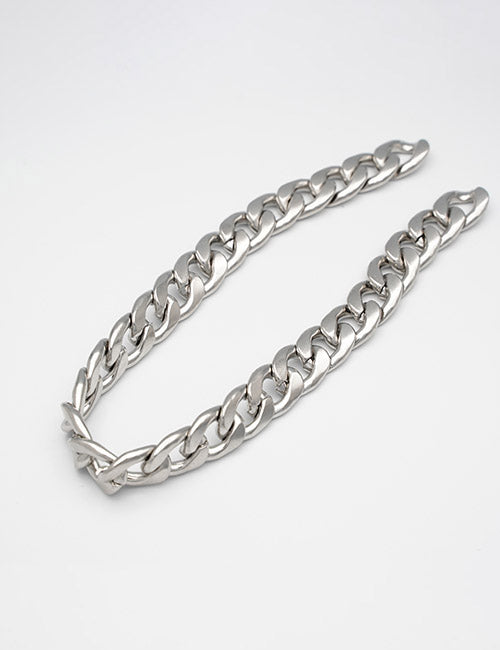 The YIPAI Chains necklace features large, interlocking silver links arranged in a curve against a plain white background.