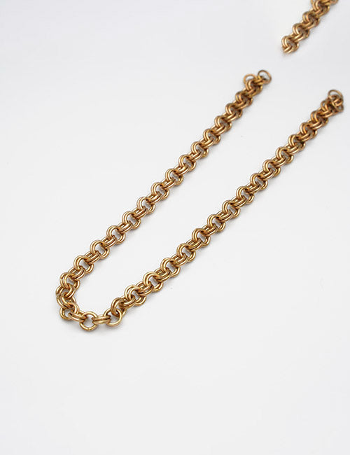 The YIPAI Chains gold chain necklace features thick, round interlocking links and is displayed on a plain white background, with part of the chain extending out of the frame in the top right corner.