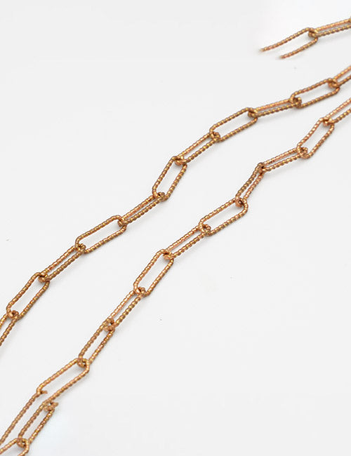 Two gold-colored Chains by YIPAI with a minimalist, elongated rectangular link design are displayed on a plain white background.