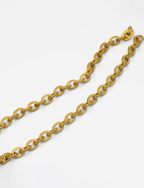 A close-up of two YIPAI Chains with oval links, featuring a textured, shiny gold finish, displayed on a white background.