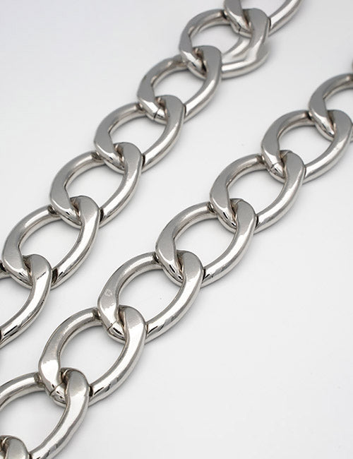 Close-up of two shiny YIPAI Chains with large, oval silver links laid parallel on a white surface.