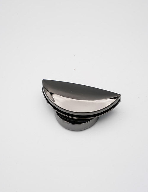 A sleek, metallic YIPAI Closures product with a glossy finish and semicircular design rests on a plain white background, showcasing its modern and minimalistic appeal.