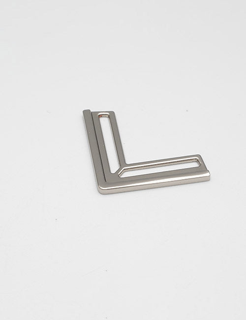 A YIPAI Closures product, featuring a metallic L-shape with a hollow rectangular design, rests on a plain white surface.