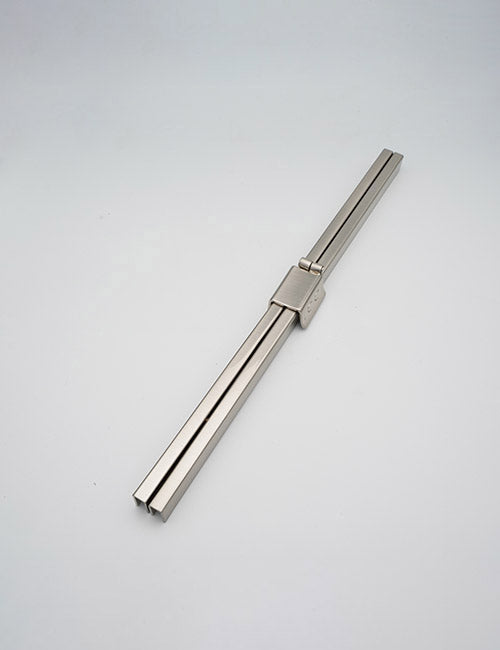 A pair of sleek, metallic YIPAI Closures rectangular chopsticks are stacked together with a matching metal clip at the center, set against a plain white background.
