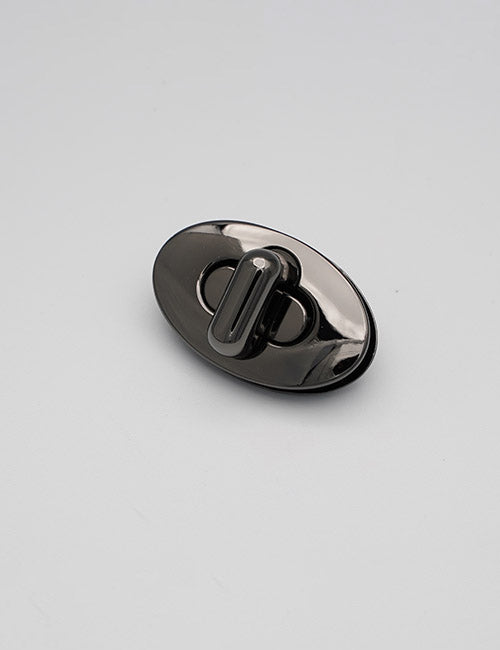 A shiny black oval-shaped YIPAI Closures twist lock clasp is displayed on a plain light gray background.