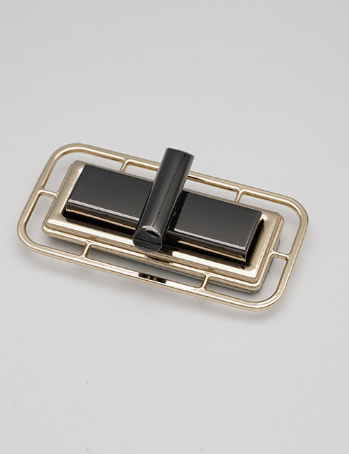 A rectangular, gold-colored YIPAI Closures clasp features a geometric black bar and block design, displayed on a plain white background.