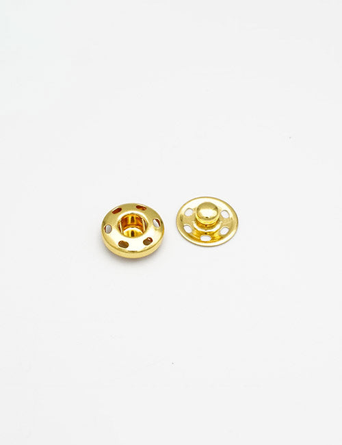 Two small, round, gold-colored metal Fasteners by YIPAI are placed on a plain white background—one showing the socket side and the other displaying the stud.