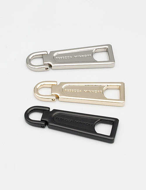 Three metal Fasteners keychain bottle openers by YIPAI—silver, gold, and black—each engraved with the brand name, arranged on a white background.