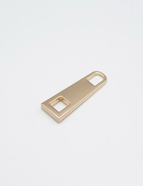 A YIPAI Fasteners gold metal piece, flat and rectangular, with a square hole on one end and an elongated oval hole on the other, shown against a plain white background.
