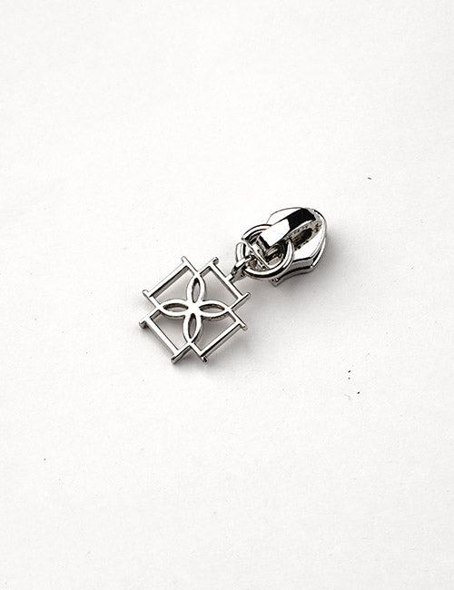 The YIPAI Fasteners silver zipper pull features a square-shaped charm with an open floral design, shown against a plain white background.