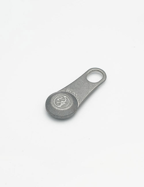 A small, flat metal fastener by YIPAI with a circular end and a hole at the other end, embossed with the DANAS logo, is displayed against a plain white background.