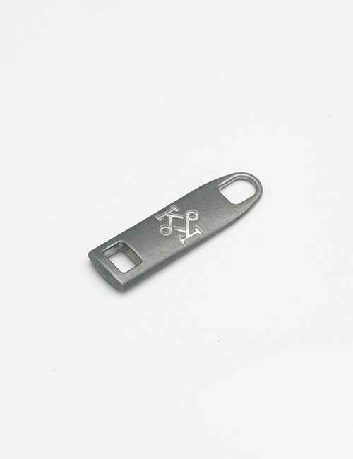 A small, flat metal YIPAI Fasteners opener features a rectangular opening on one end, a rounded hole on the other, and an engraved center design, all set against a plain white background.