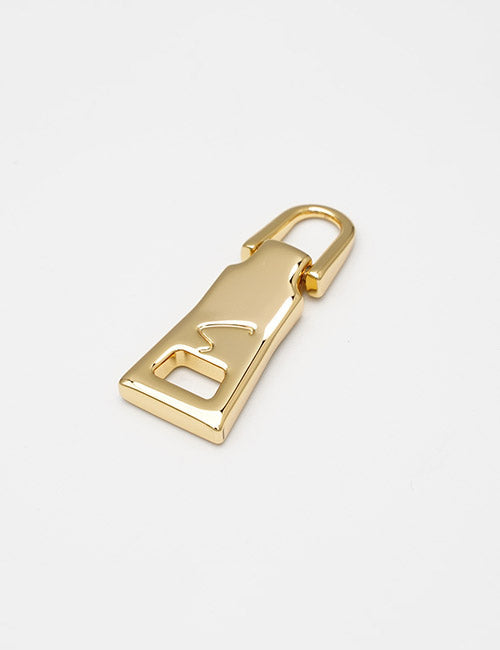 The YIPAI Fasteners gold zipper pull features a sleek, modern design with a stylized S cutout on its flat surface, shown on a plain white background.