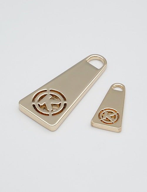 Two gold-colored YIPAI Fasteners keychains, each with a cut-out trapezoid design and a rounded hole for keyring attachment, are displayed on a plain white background.