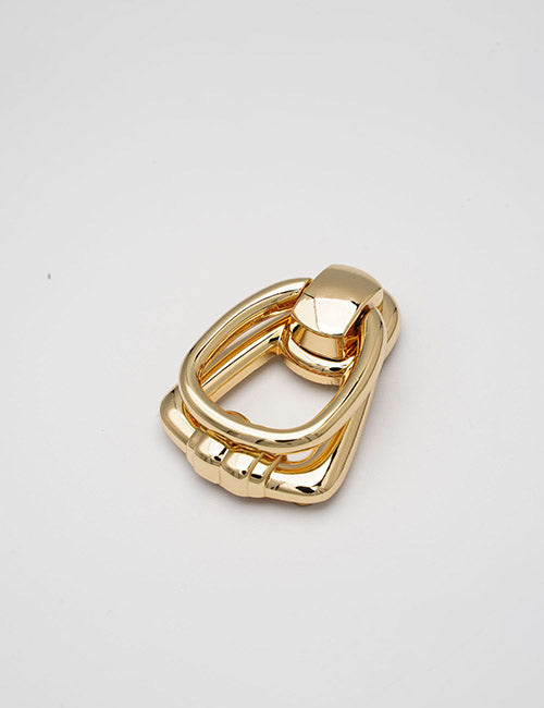 The YIPAI Handles is a shiny gold metal keychain or decorative clasp featuring a geometric, angular design, shown on a plain white background.