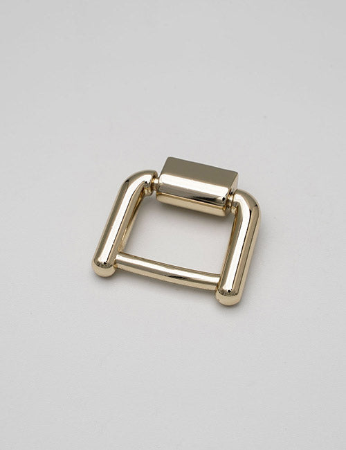A rectangular, gold-colored metal YIPAI Handles buckle with rounded edges is displayed on a plain light gray surface.