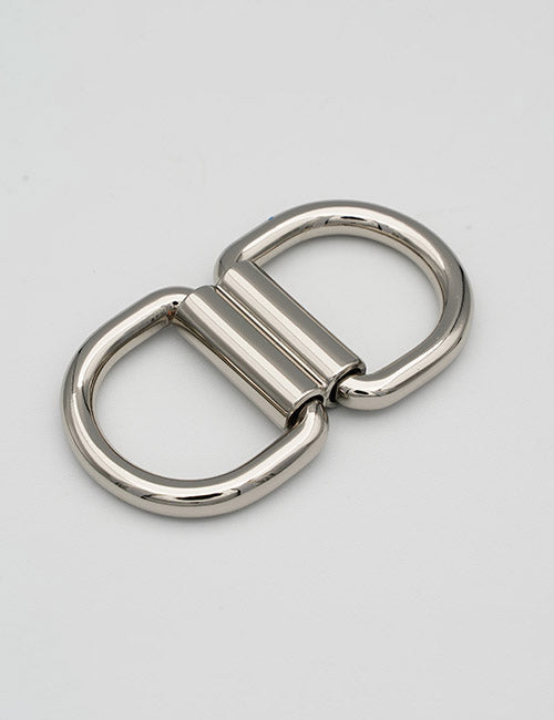 A shiny, metallic YIPAI Handles double D-ring swivel connector rests on a plain light gray surface, with two D-shaped rings joined at the center by a cylindrical hinge.