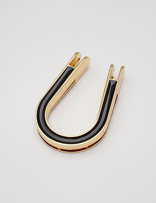 A sleek, modern gold and black YIPAI Handles product lies on a plain light gray surface.