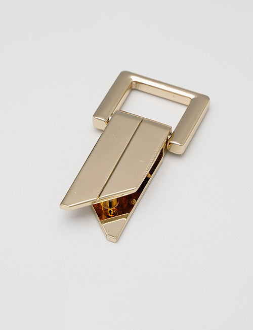 The YIPAI Handles feature a gold metal clasp with a geometric, angular design—rectangular top and pointed ends—displayed on a plain white surface.
