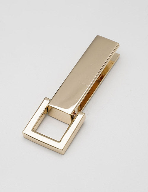 A gold-colored rectangular metal handle by YIPAI, featuring a square-shaped loop at one end, showcases a modern minimalist design and is displayed on a plain light gray background.