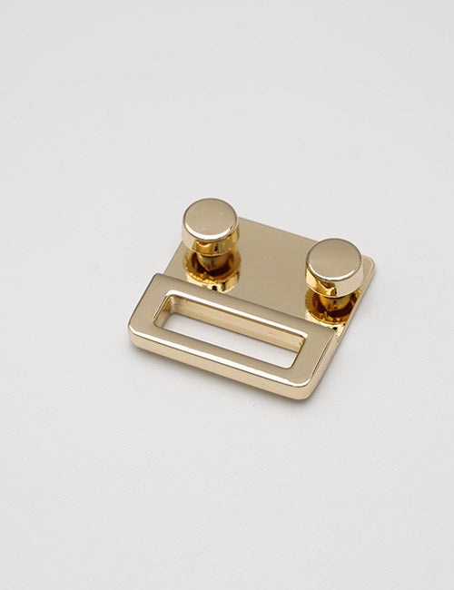 The YIPAI Handles is a small, shiny gold metal clasp featuring two round studs and a rectangular slot, displayed against a plain white background.
