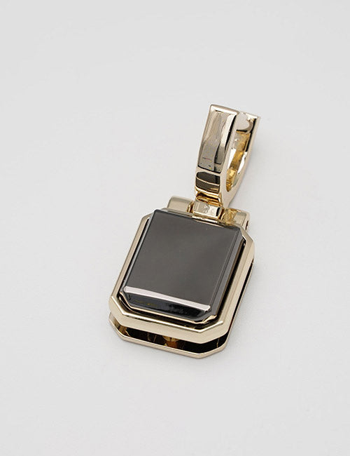 The YIPAI Handles pendant features a gold rectangular design with a glossy black stone at the center and a thick, polished bail for attaching to a chain, shown against a plain light background.
