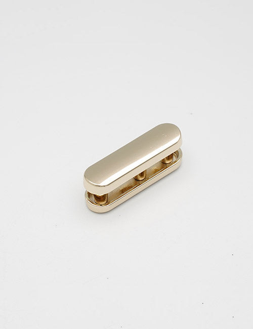 A small, metallic, gold-colored oval-shaped YIPAI handle with a smooth top and open sides is placed on a plain white background.