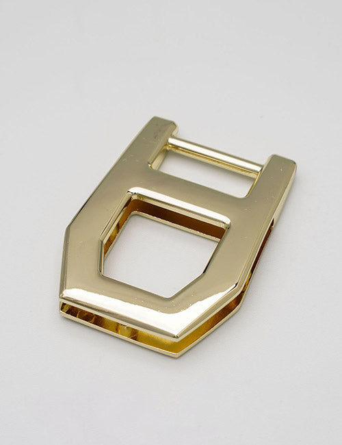 The YIPAI Handles feature a geometric, gold-colored metal buckle with rectangular and hexagonal cutouts, elegantly displayed on a plain light background.