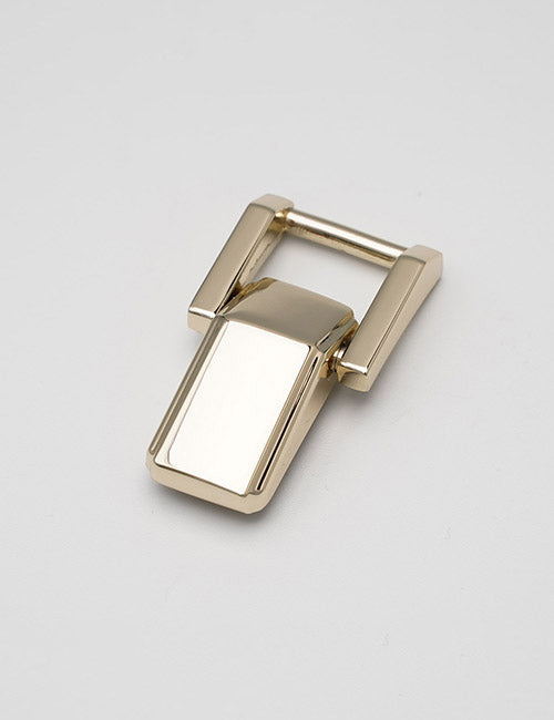 A shiny, gold rectangular metal YIPAI Handles buckle with a modern, angled design is displayed on a plain light gray background.