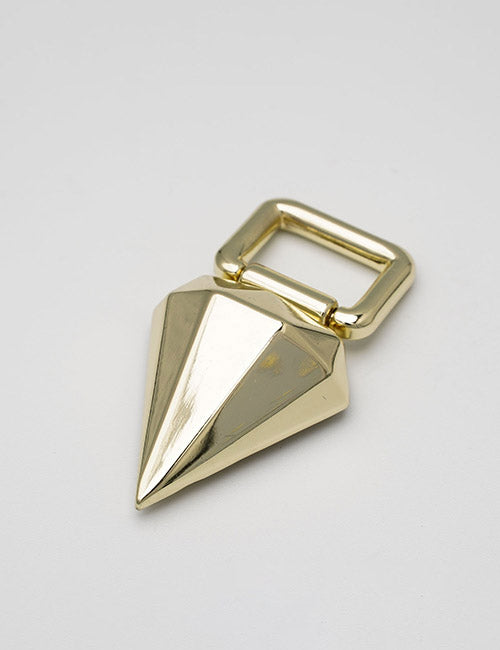 The YIPAI Handles feature a shiny gold geometric pendant with a pointed faceted shape and a rectangular loop at the top, displayed on a plain light gray surface.