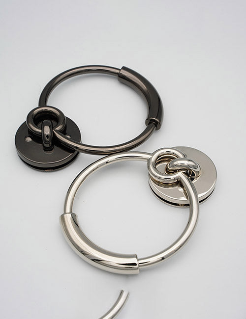 Two YIPAI Handles keyrings—one black, one silver—each with a round flat tag, are shown on a plain white background.